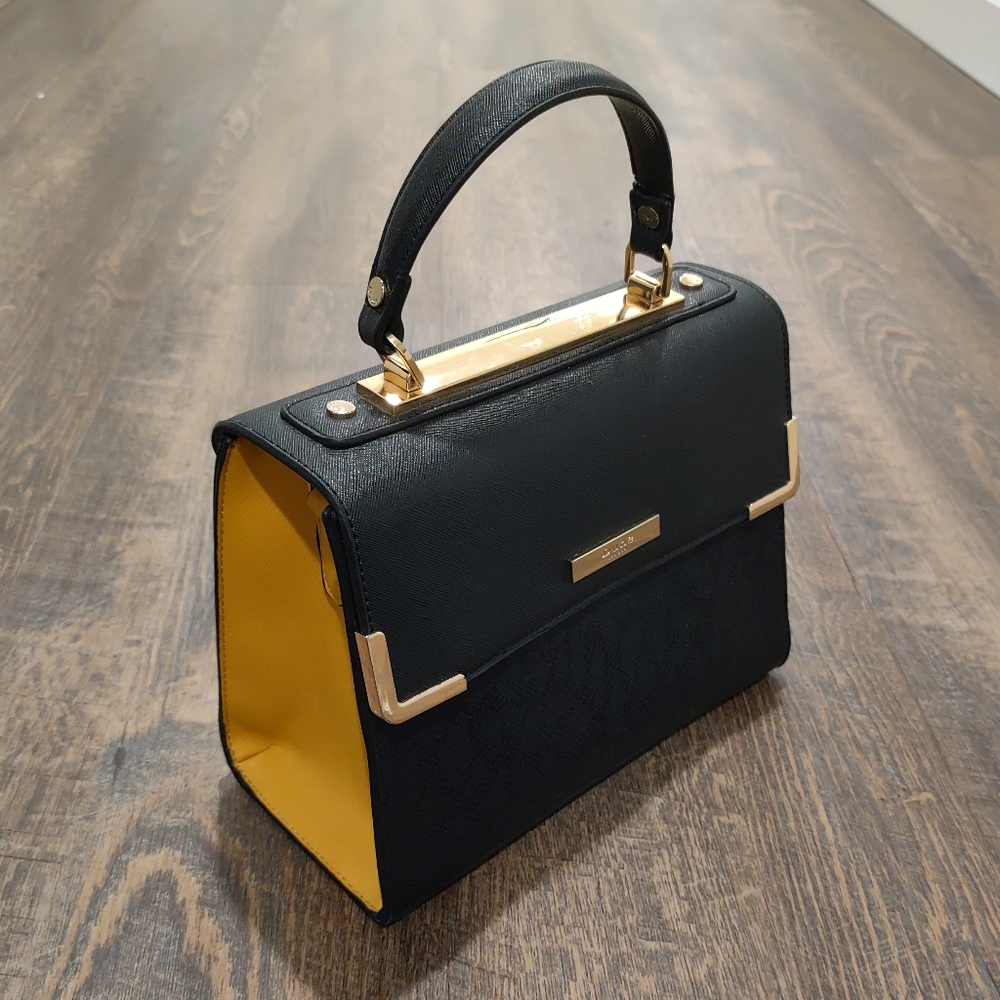 Dune black purse with yellow sides, gold hardware, front snake print